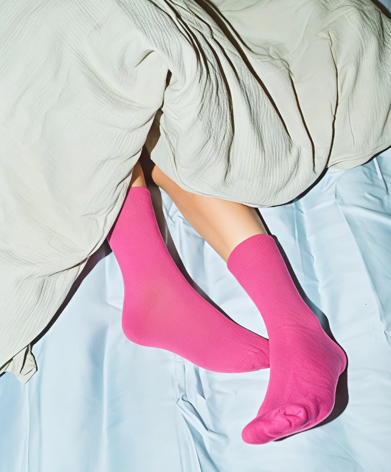 Pink socks under the duvet in a keygo apartment